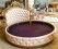 Modern Royal Round Bed with Quilted Leatherette Upholstery & Ornate Metal Crown Headboard